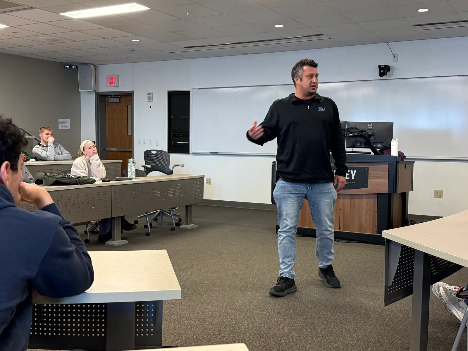 Jay speaking with college students in a classroom