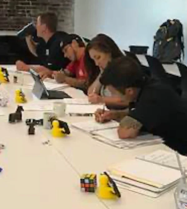 The RCV team working together at a table during a business coaching session in 2017